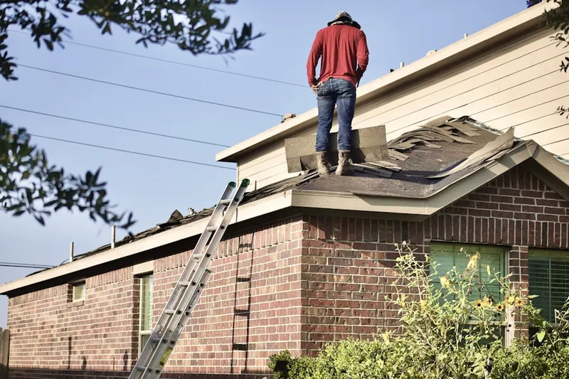 Professional roofer working on a residential roof in Mather